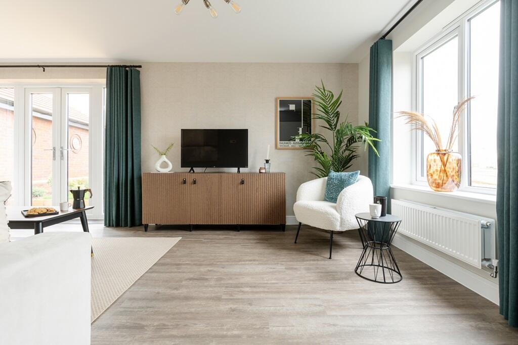 Large window and French doors flood the lounge with light