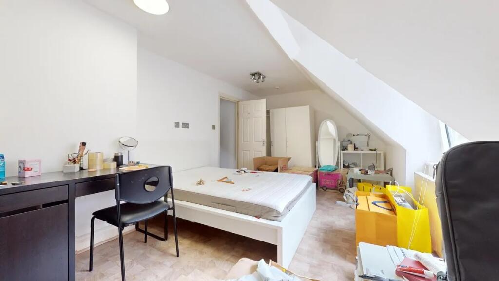 Bright and airy double bedroom with a large sla...