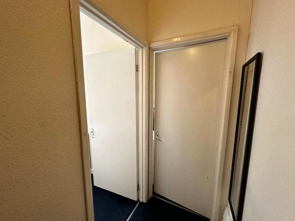 A tidy and well-maintained hallway leading to v...
