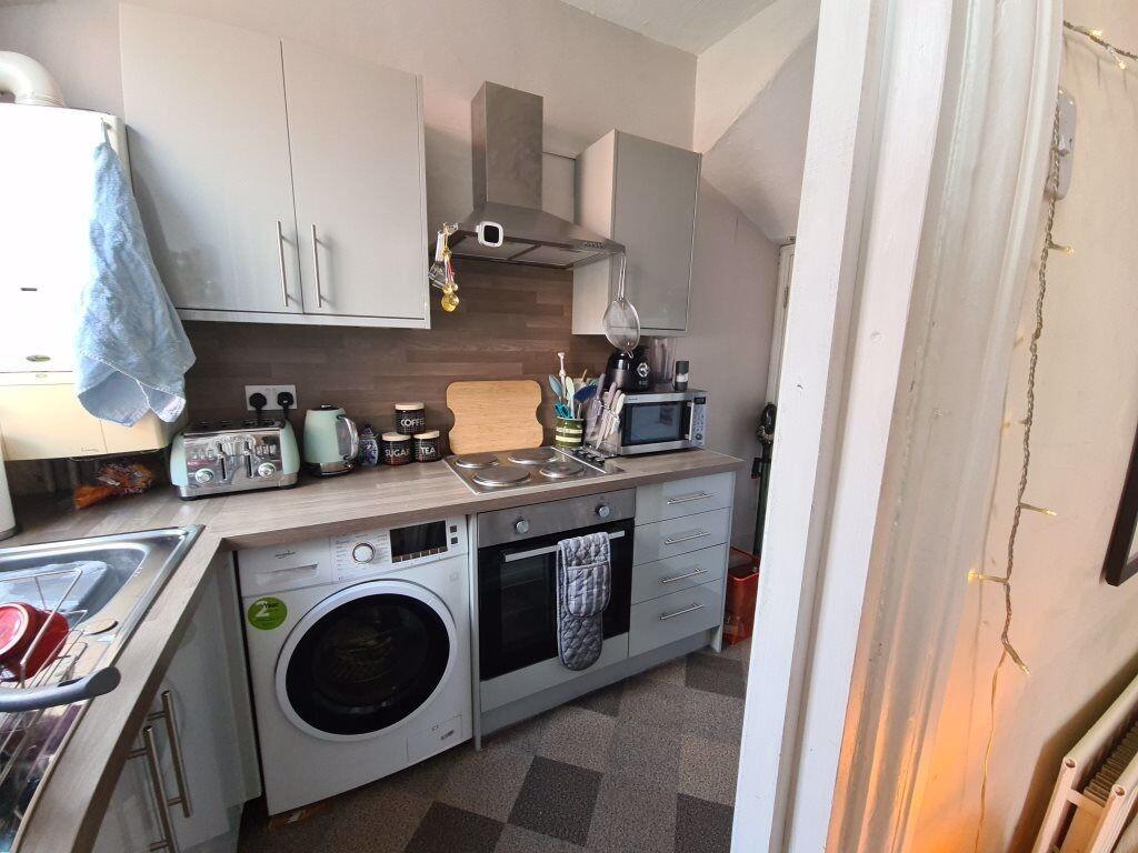 A compact kitchen area featuring essential appl...