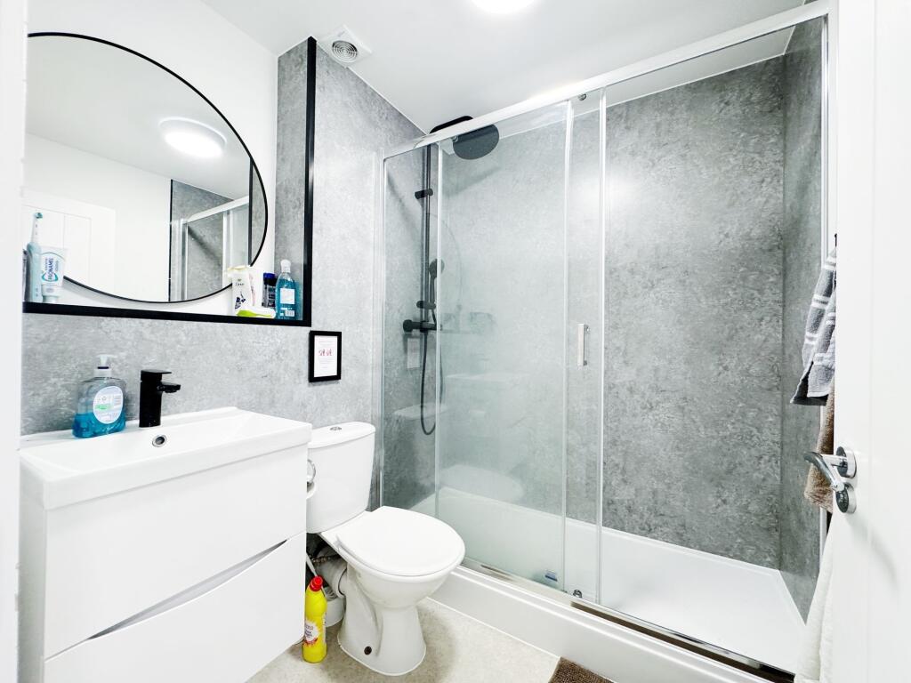 Bright modern bathroom with a walk-in shower an...