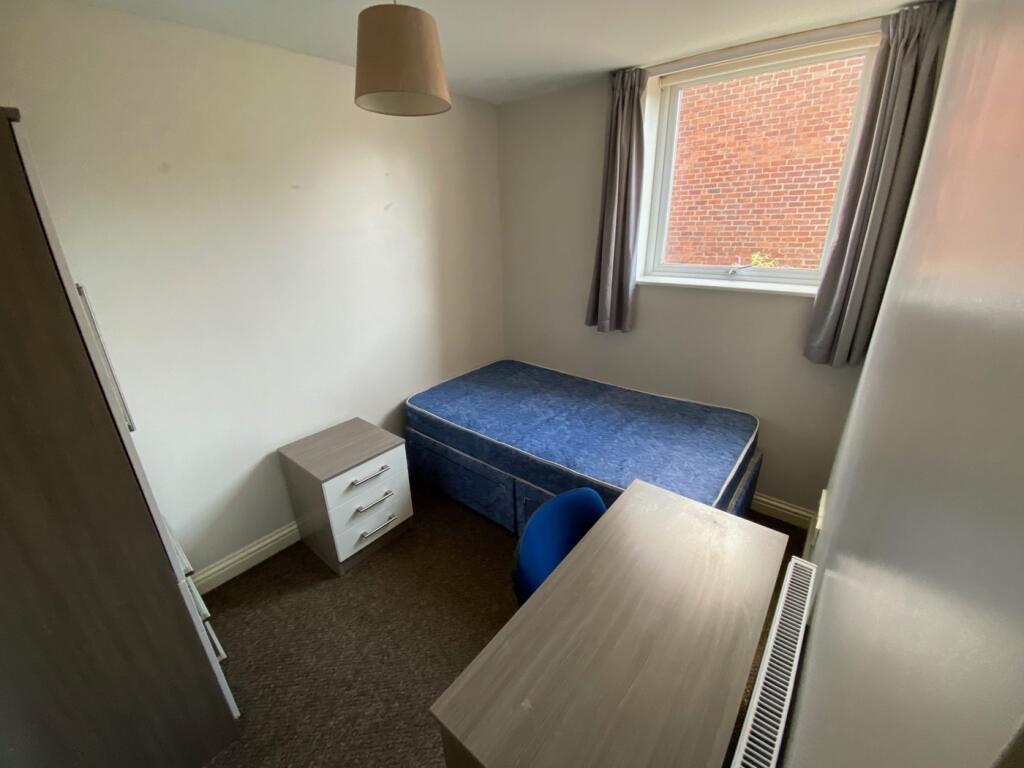 A bright and tidy double bedroom featuring a co...