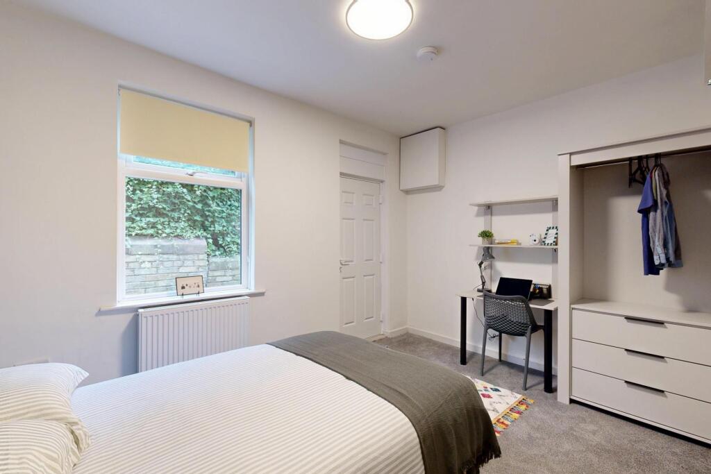 Bright and airy bedroom featuring a comfortable...