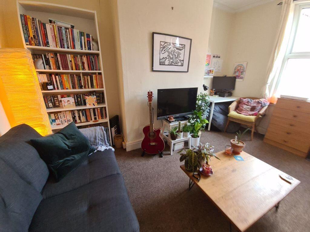 A bright and welcoming living room featuring co...