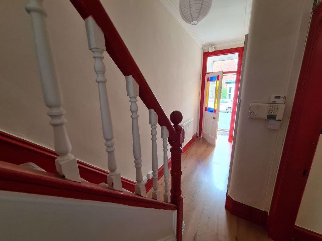 A bright hallway featuring polished wooden floo...