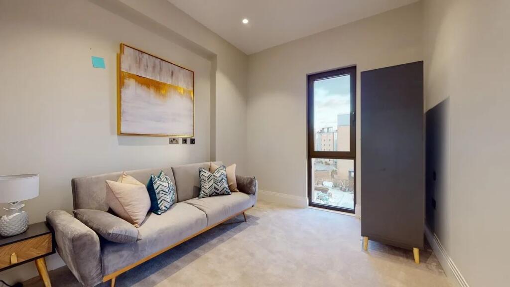 A stylish and cozy living room featuring a comf...