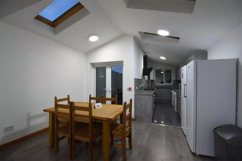 Bright and modern kitchen with skylights and Fr...