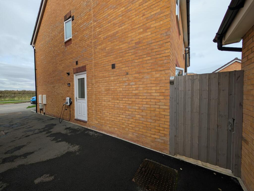 Side of the house with electric charger
