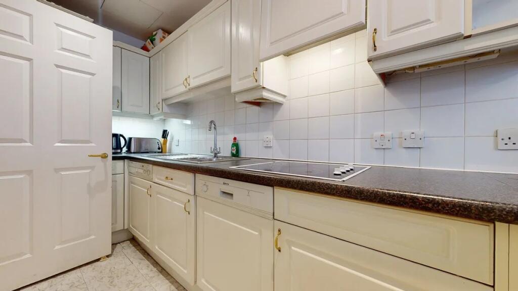 Bright and clean kitchen featuring ample cabine...