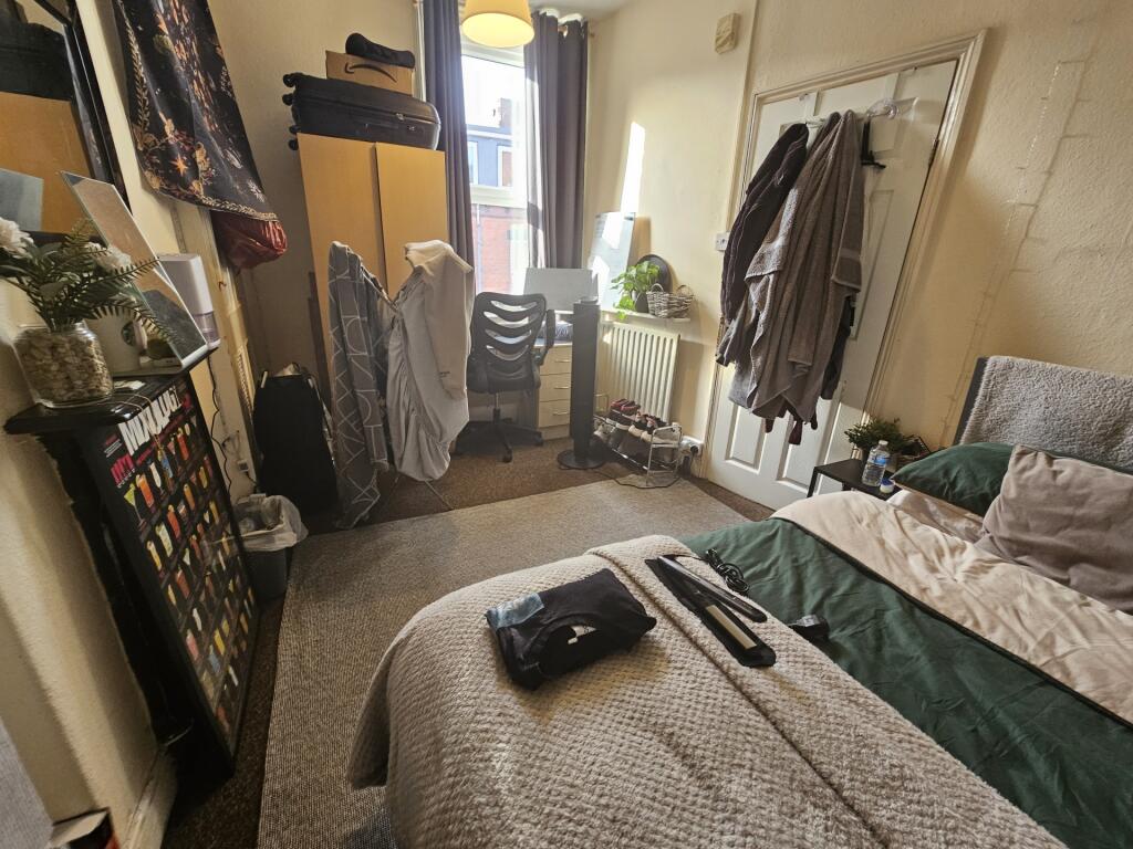 A cozy master bedroom featuring a comfortable d...