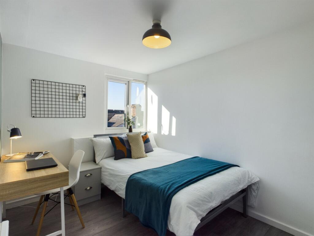 A bright and inviting double bedroom featuring ...