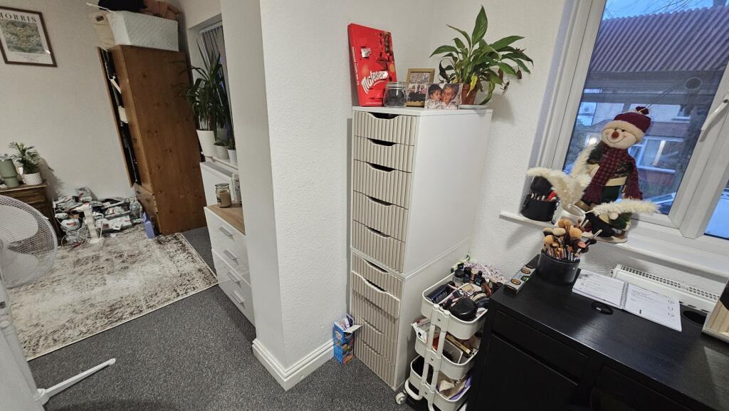 A cozy living room area featuring a bright wind...