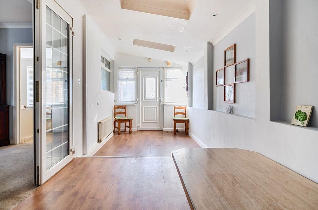 Living/dining area with kitchen/utility area