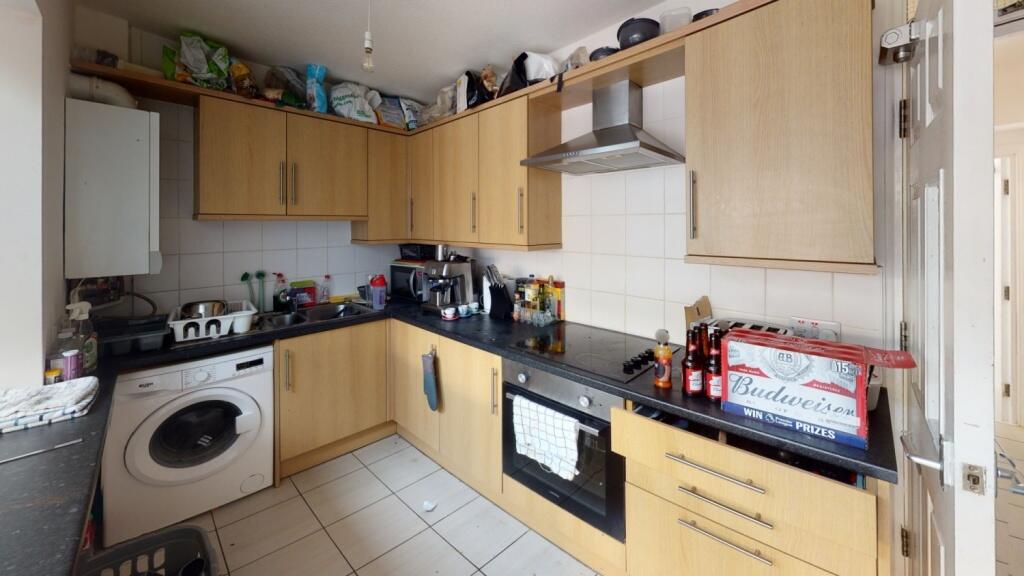 A practical kitchen space featuring wooden cabi...