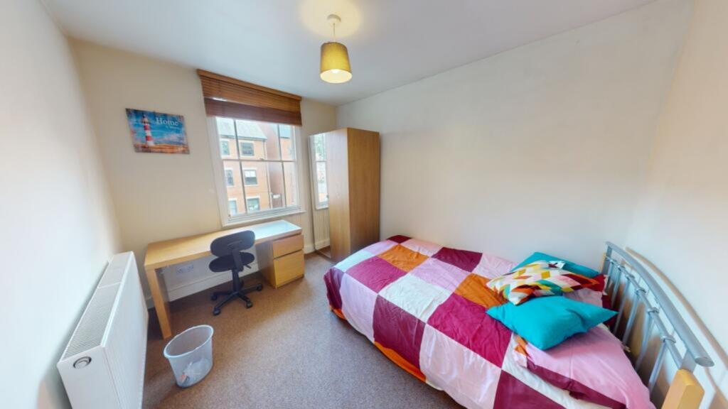 A bright and inviting double bedroom featuring ...