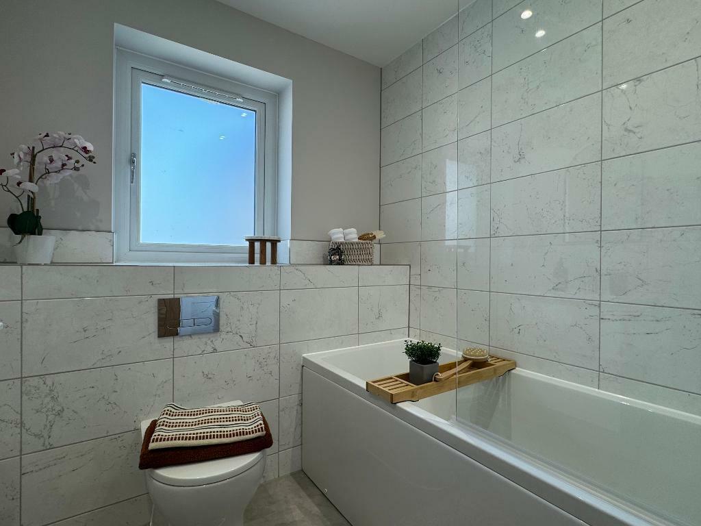 Family bathroom with shower over bath