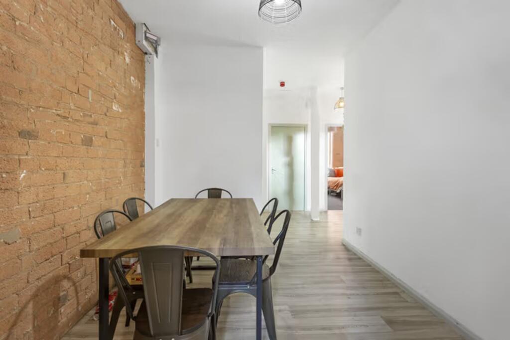 A stylish and inviting communal workspace featu...