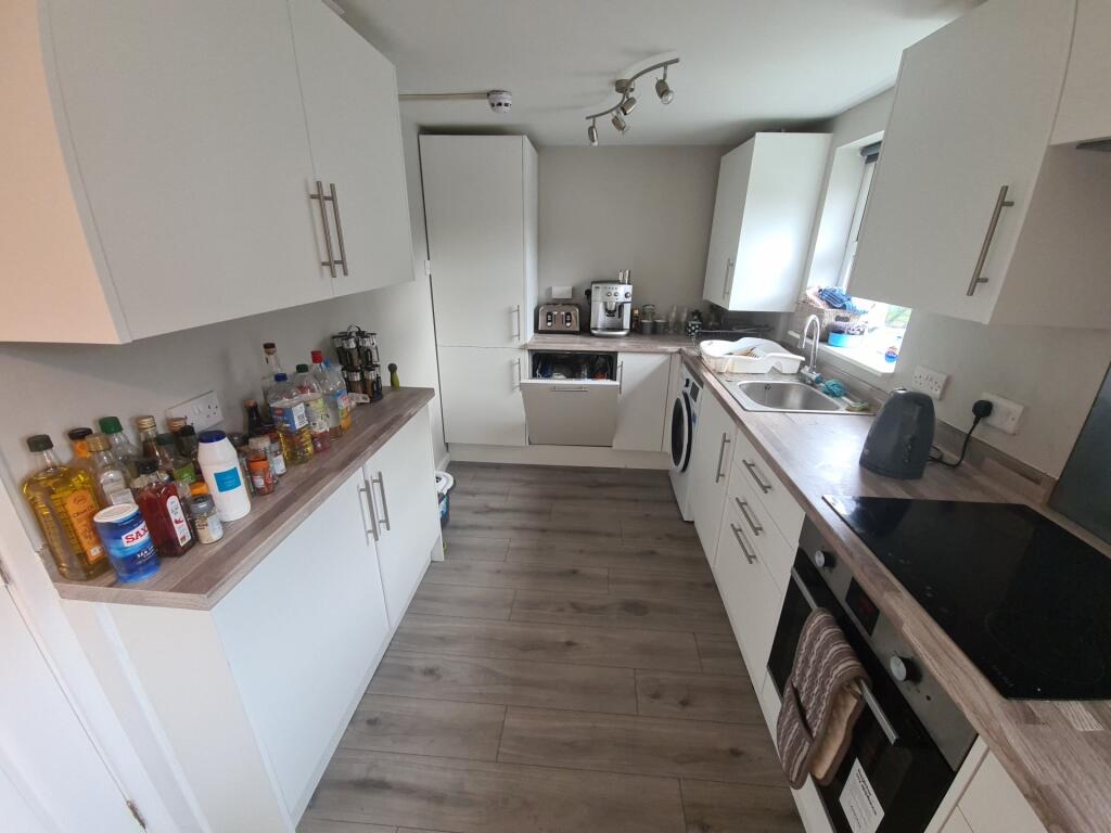 Bright and modern kitchen featuring sleek white...
