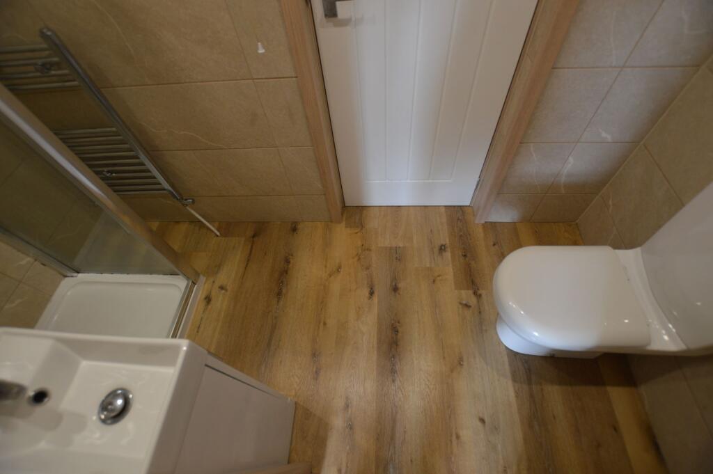 A modern bathroom featuring a sleek white toile...