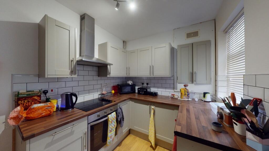 Bright and modern kitchen featuring wooden coun...