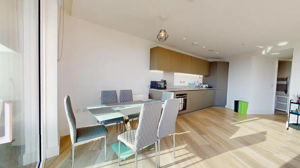Bright and modern kitchen featuring sleek cabin...