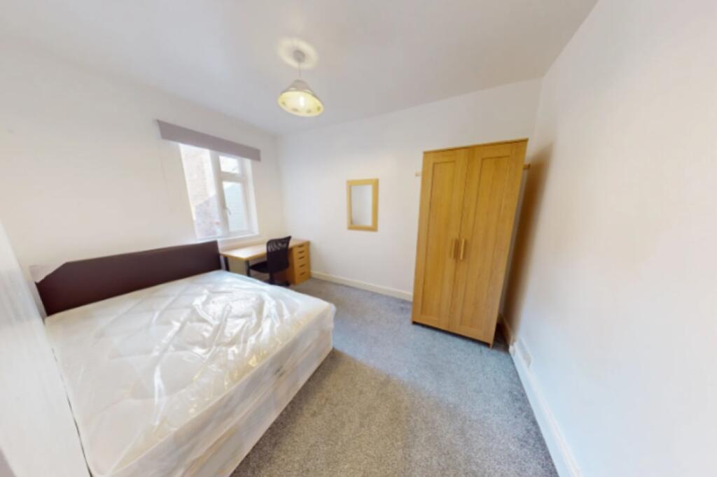 Spacious double bedroom featuring a comfortable...