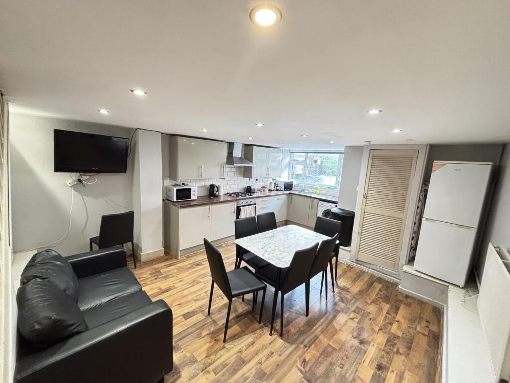 A bright and modern living room featuring ample...