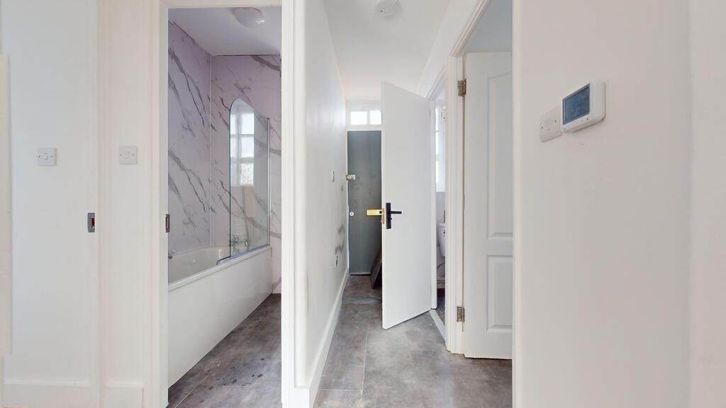Bright and clean hallway featuring white walls ...