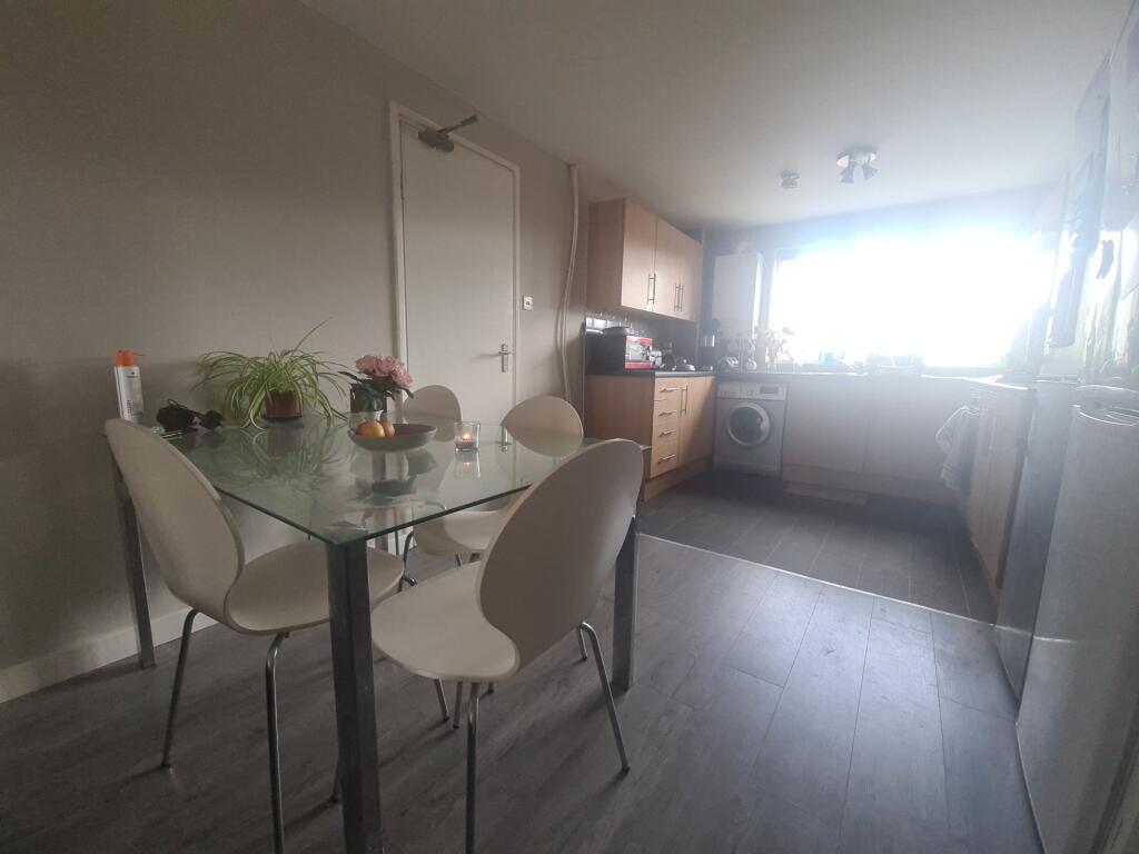 A bright and tidy kitchen featuring a glass din...
