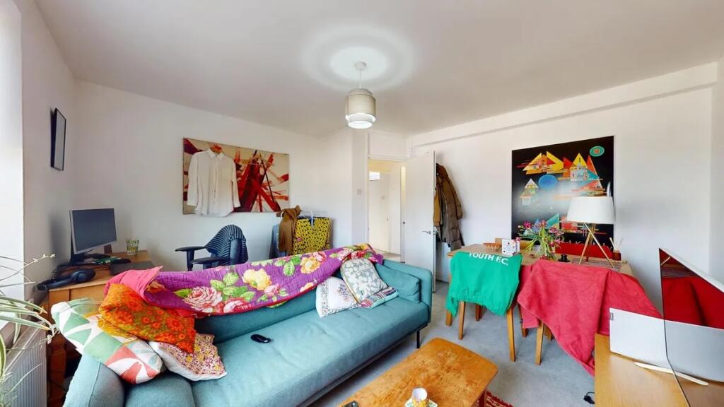 A bright and cozy living room featuring a comfo...