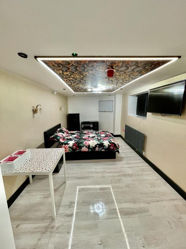 A modern master bedroom featuring a comfortable...