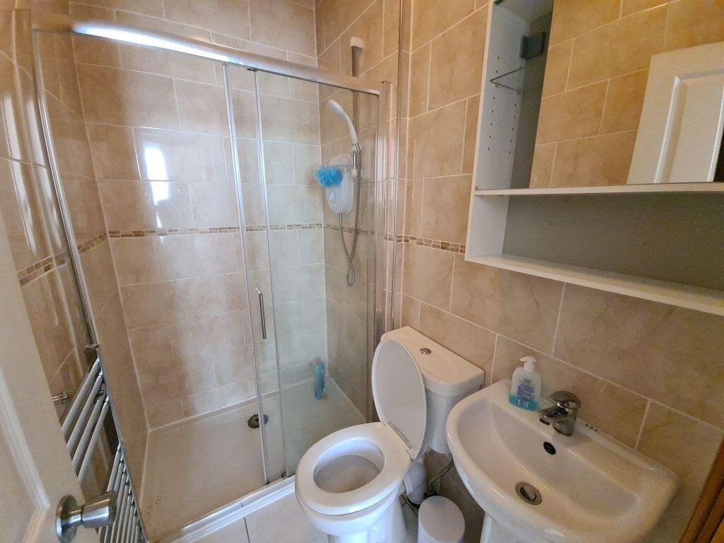 Bright and clean bathroom suite featuring a mod...