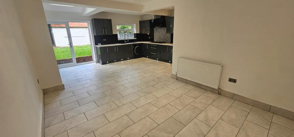This modern kitchen features sleek cabinetry an...
