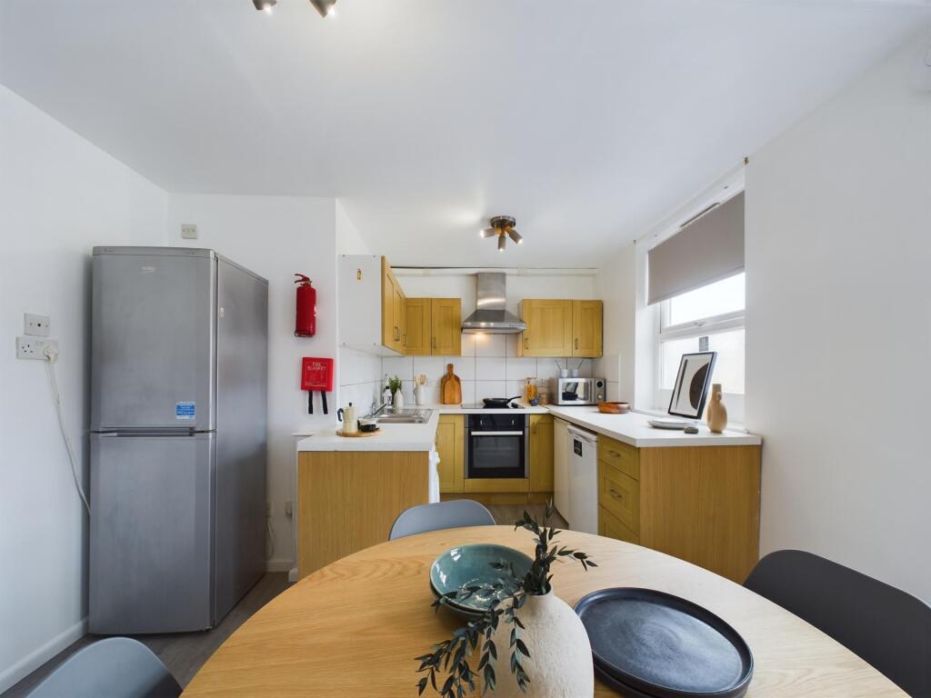 Bright and welcoming kitchen with ample natural...