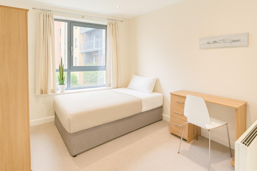 Bright and tidy single bedroom featuring a comf...