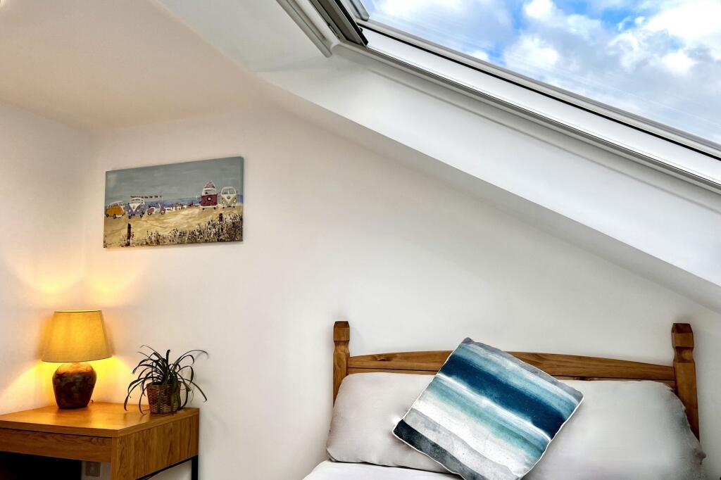 A bright and cozy double bedroom featuring a co...