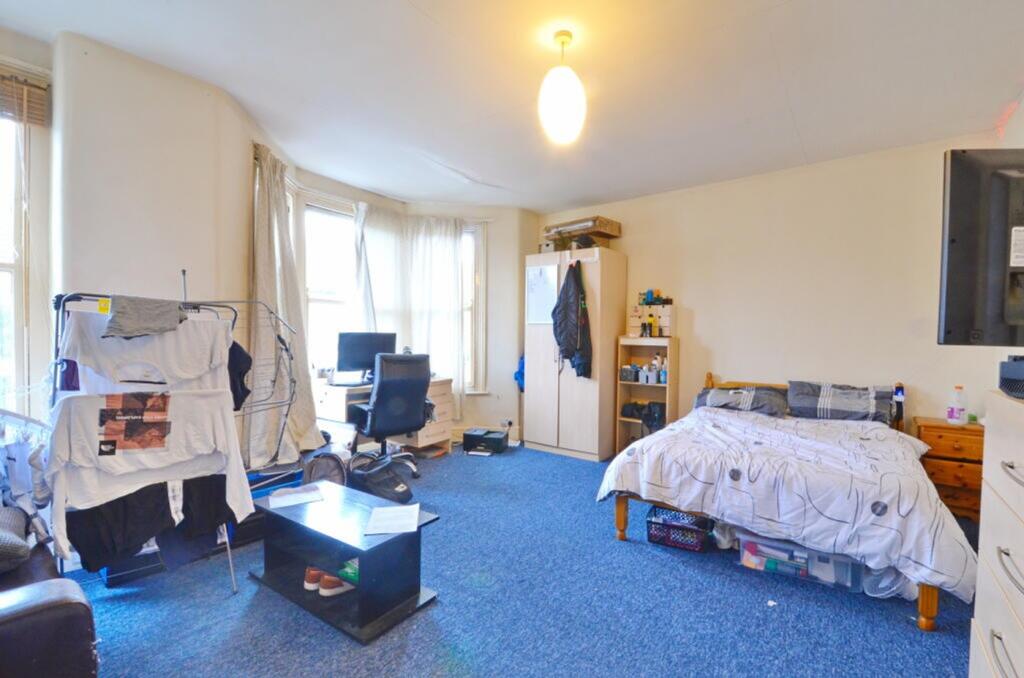 A cozy double bedroom featuring ample natural l...