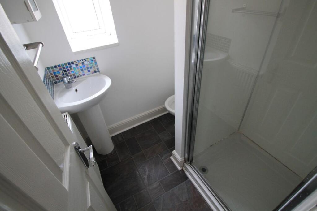 Bright and modern bathroom featuring a spacious...