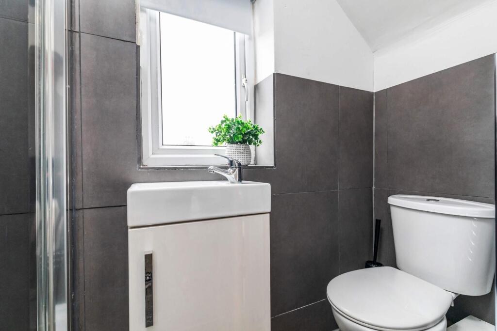 A clean and well-lit bathroom with modern fixtu...