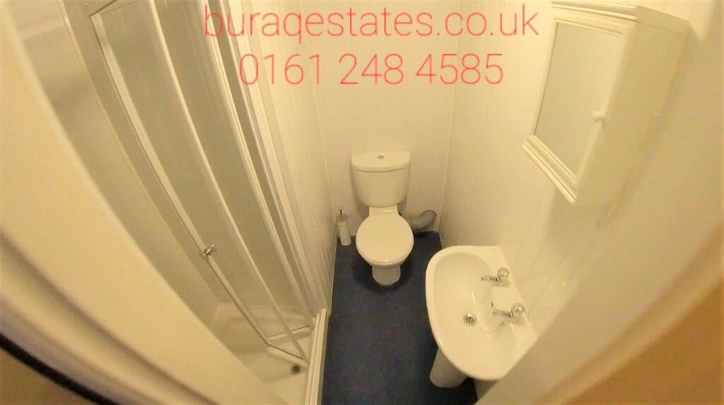 Compact and clean single toilet featuring a whi...