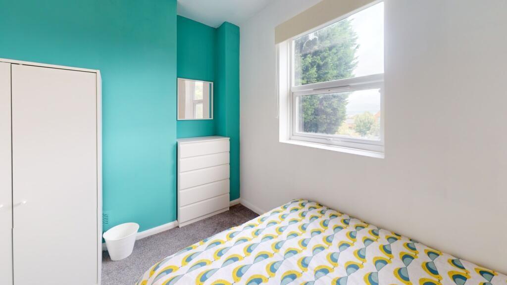 A bright and tidy single bedroom featuring a co...