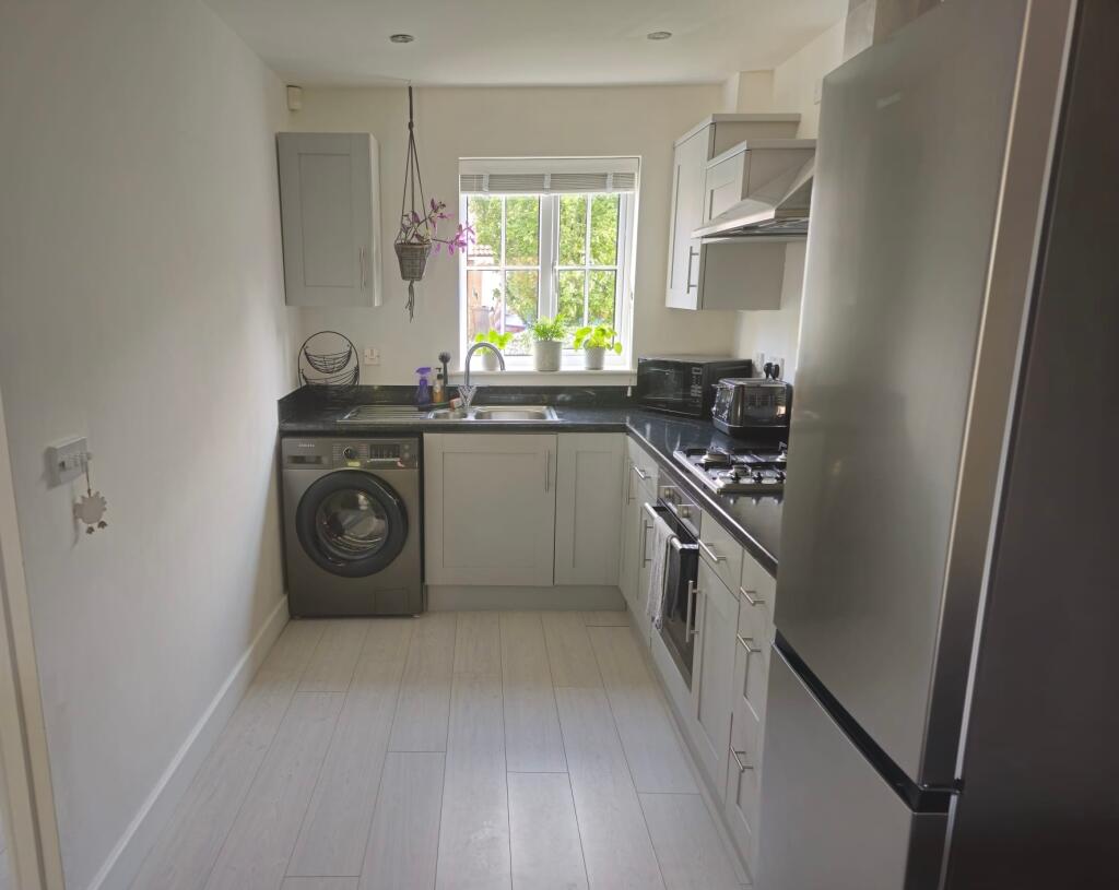 Bright and modern galley kitchen featuring slee...