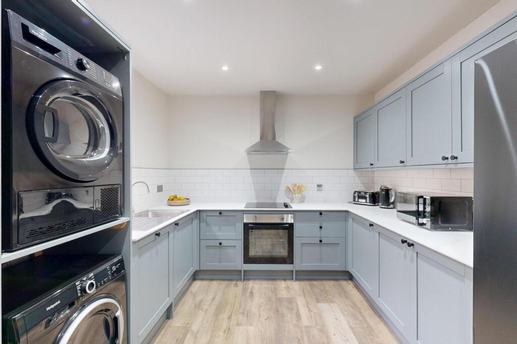 Bright and modern kitchen with light blue cabin...