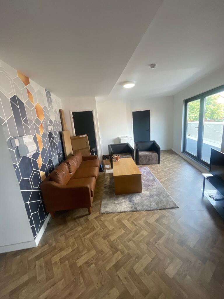 A modern living room featuring stylish wooden h...