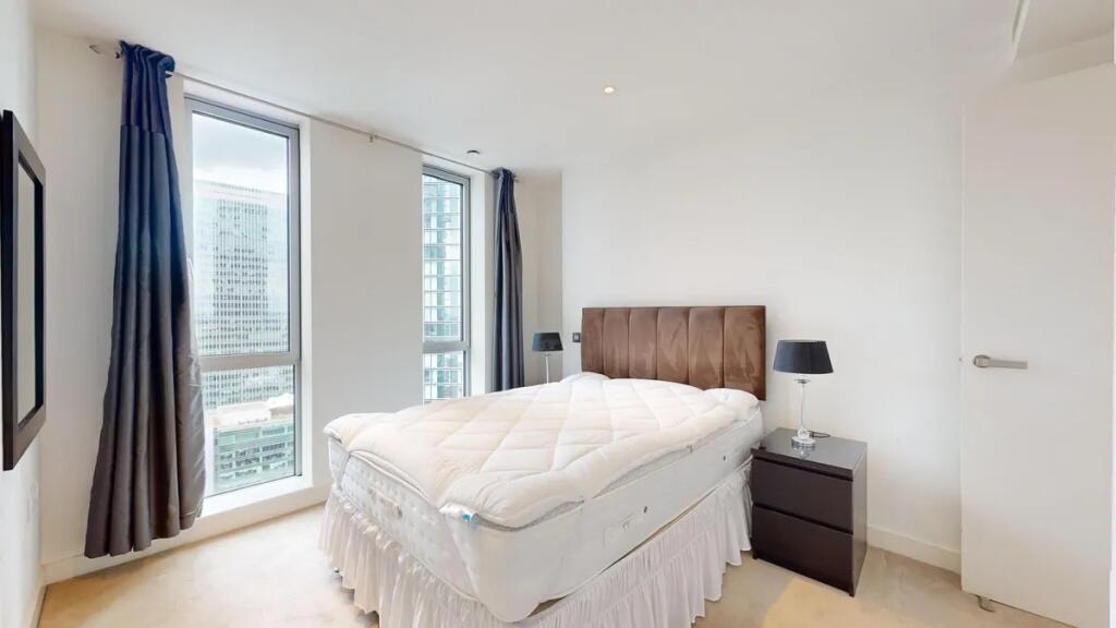 Bright and modern double bedroom featuring larg...