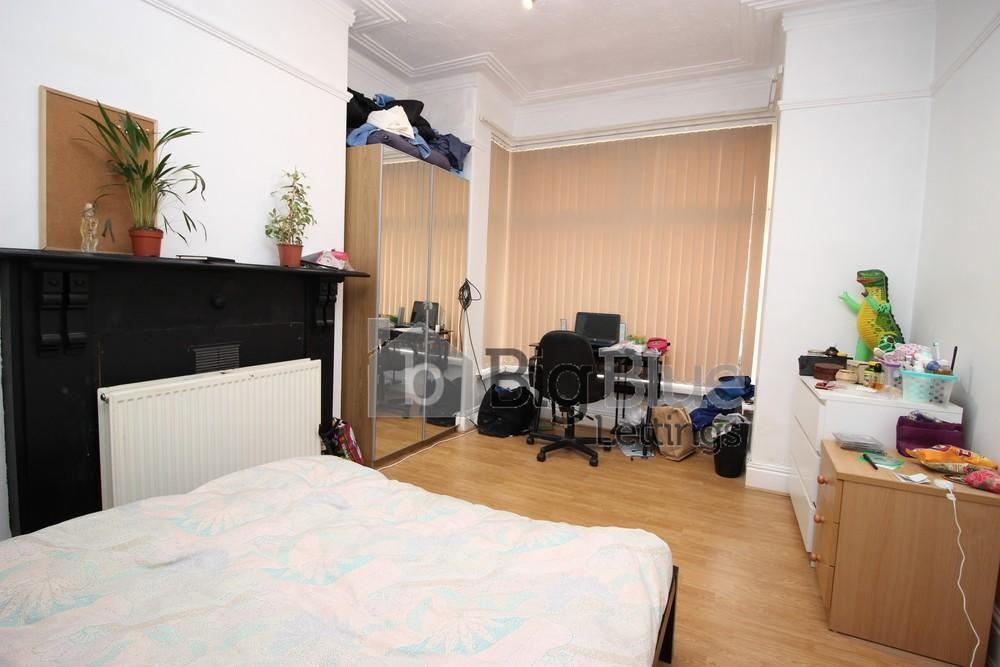 Bright and spacious bedroom featuring a comfort...