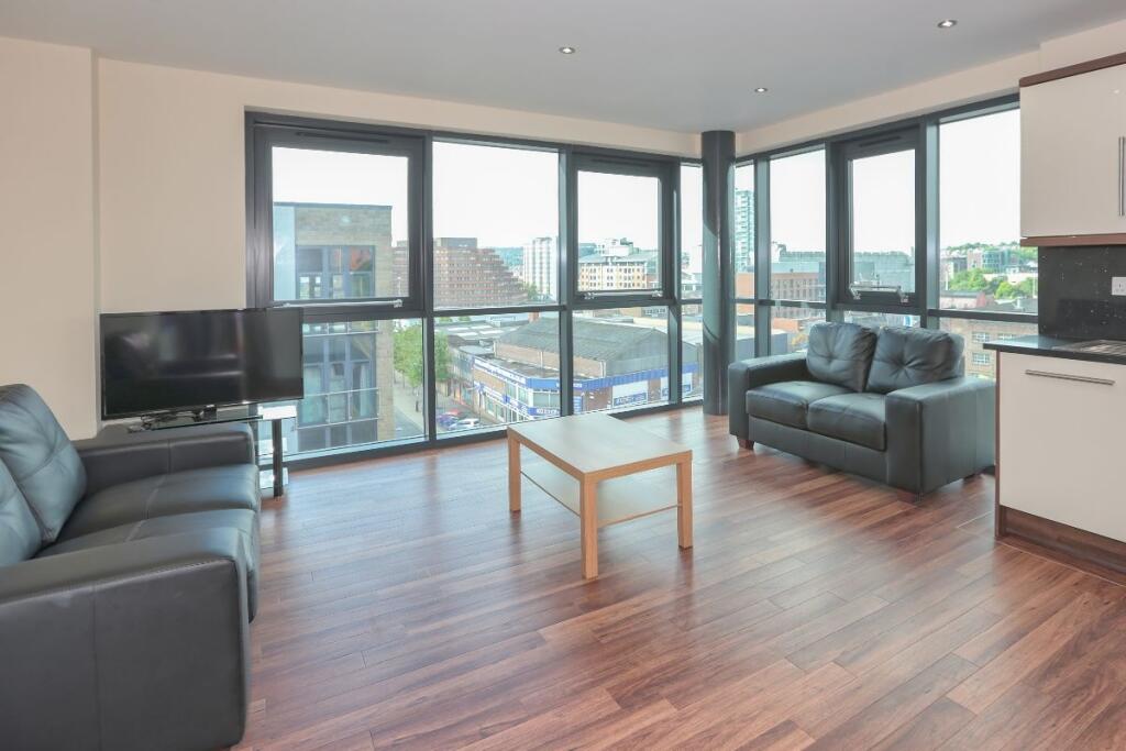 Bright and modern living room featuring large c...