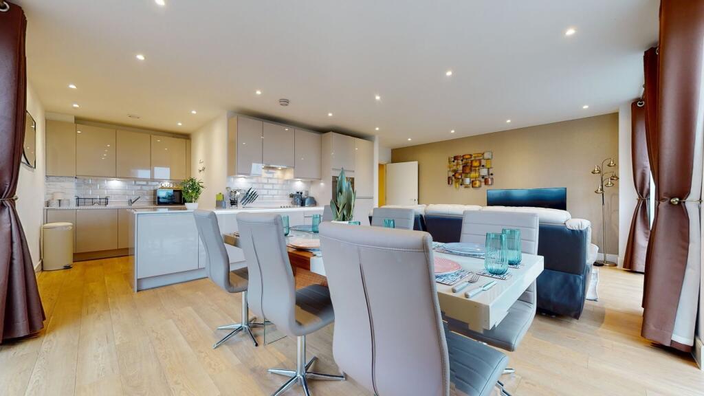 A modern, spacious open-plan living room and ki...