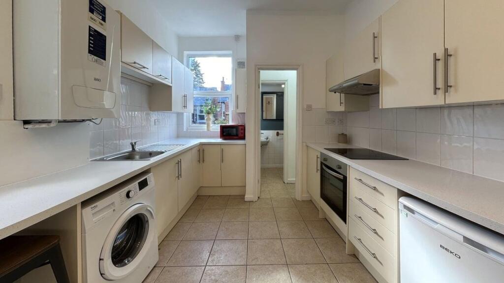 Bright and modern kitchen with ample storage, p...