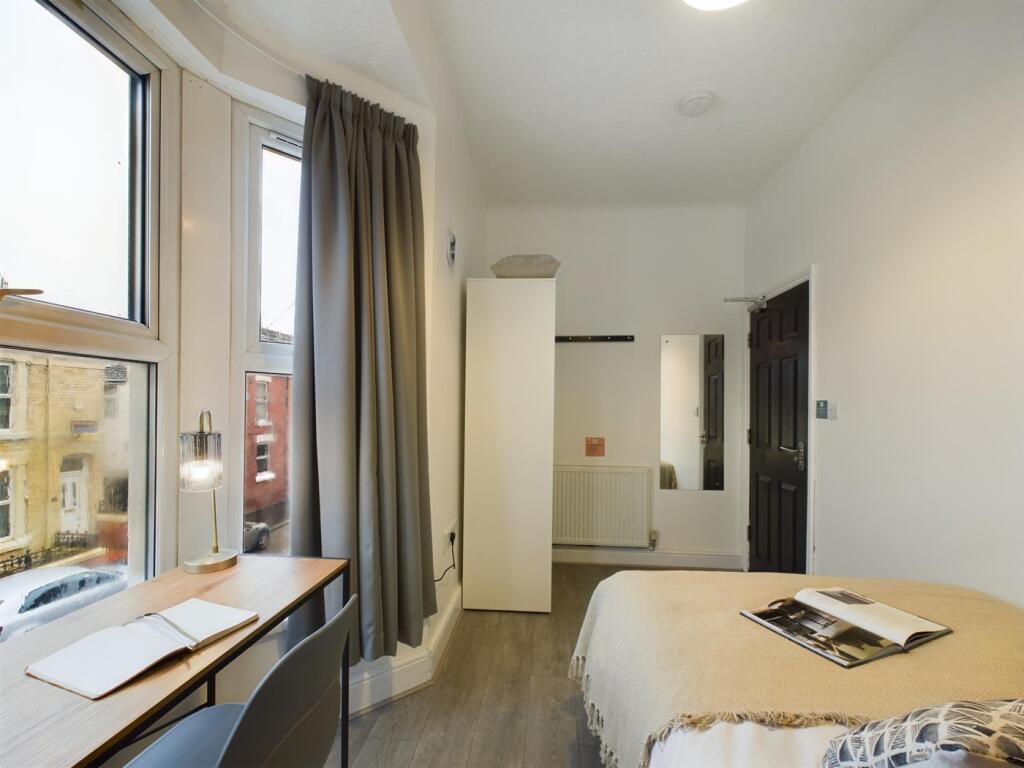 A bright and inviting double bedroom featuring ...